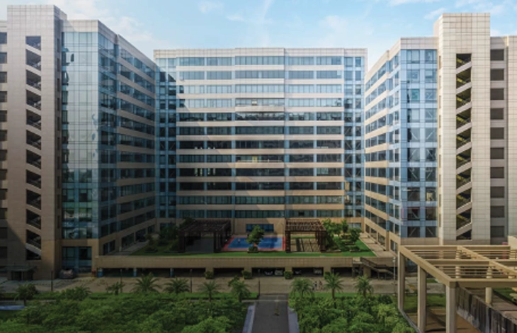 View of the Candor TechSpace buildings with glass facades and landscaped spaces at the ground level, located in Sector 135, Noida.